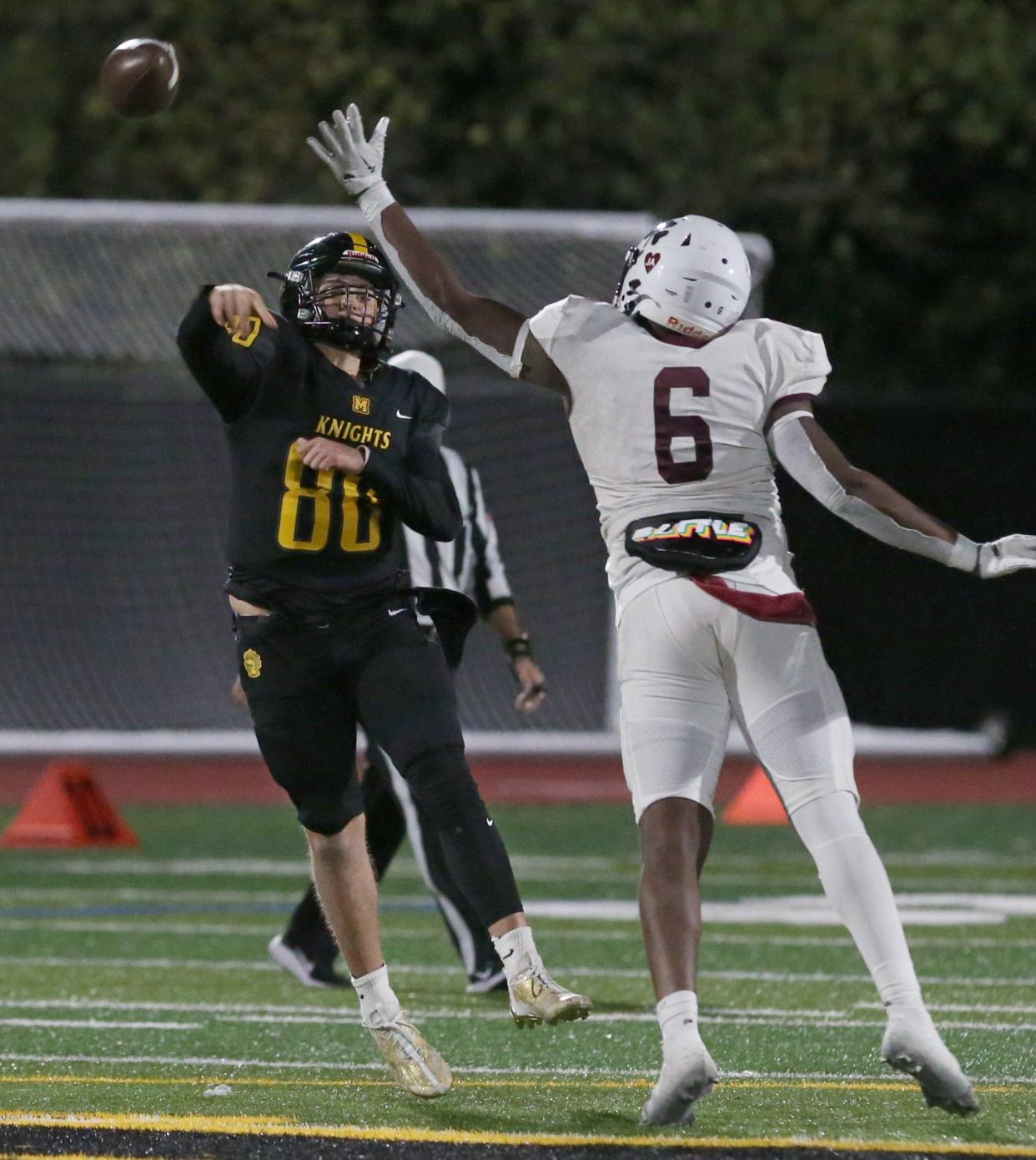 McQuaid quarterback Will DiMarco throws on the run as he scrambles away from Aquinas's Quante Gillians.