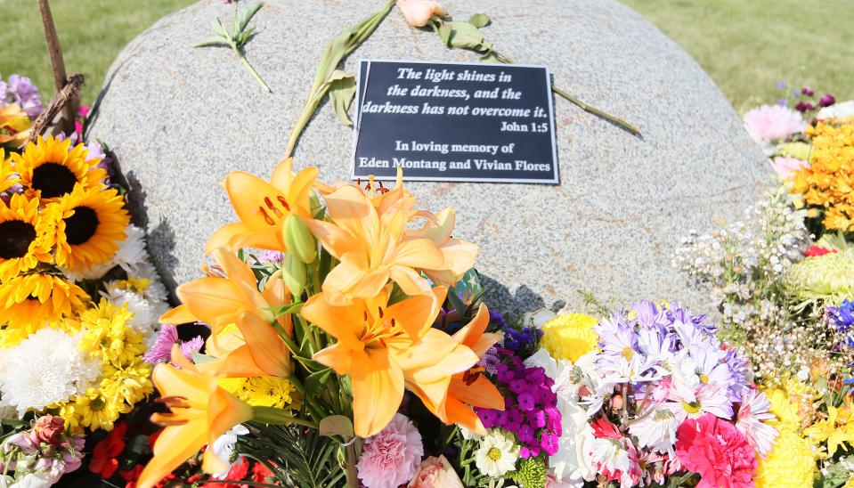 People lay down flowers to tribute Eden Montang and Vivian Flores, one year after the murders at the Cornerstone Church's parking Sunday, June 4, 2023, in Ames, Iowa.