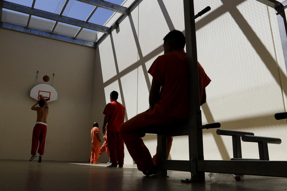 FILE - In this Aug. 28, 2019, file photo, detainees exercise at the Adelanto ICE Processing Center in Adelanto, Calif. The Trump administration has awarded four contracts worth billions of dollars to operate private immigration detention centers in California, less than two weeks before a new state law forbidding them takes effect. (AP Photo/Chris Carlson, File)