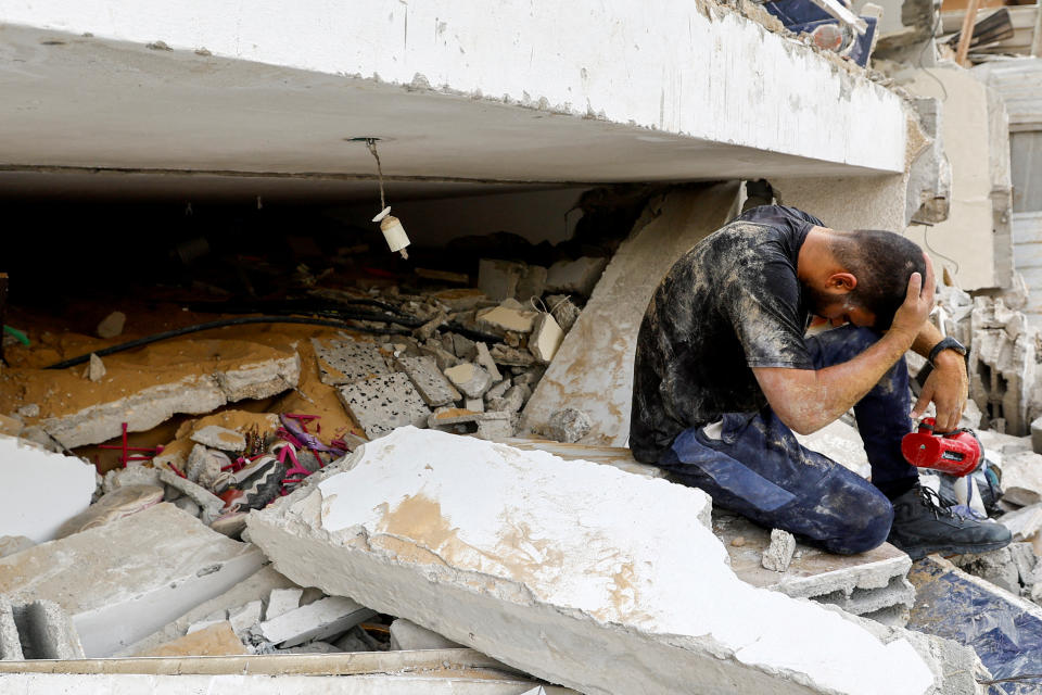 A man reacts as he works to remove bodies from under the rubble of a house in the southern Gaza Strip on Monday. (Ibraheem Abu Mustafa/Reuters)