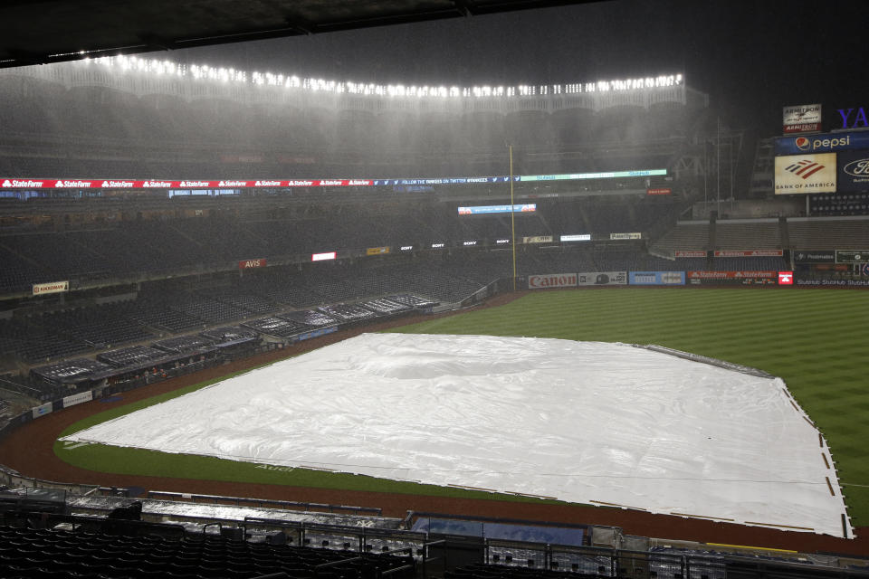 Heavy rain falls interrpting a baseball game between the New York Yankees and the Philadelphia Phillies, Monday, Aug. 3, 2020, at Yankee Stadium in New York. (AP Photo/Kathy Willens)