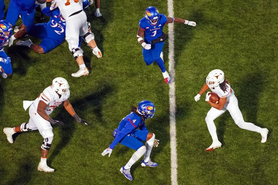 Texas running back Jonathon Brooks looks for room as left tackle Kelvin Banks Jr., left, tries to make that happen during last year's win over Kansas. Brooks figures to play a key role as Texas replaces Bijan Robinson in the running game, and he'll need Banks and the offensive line to clear more paths.
