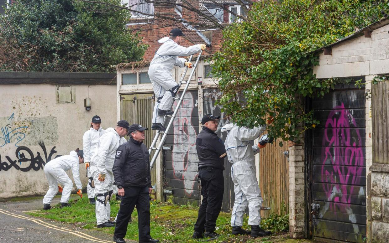 Police searching Walpole Lane, Boscombe, after the murder investigation was launched