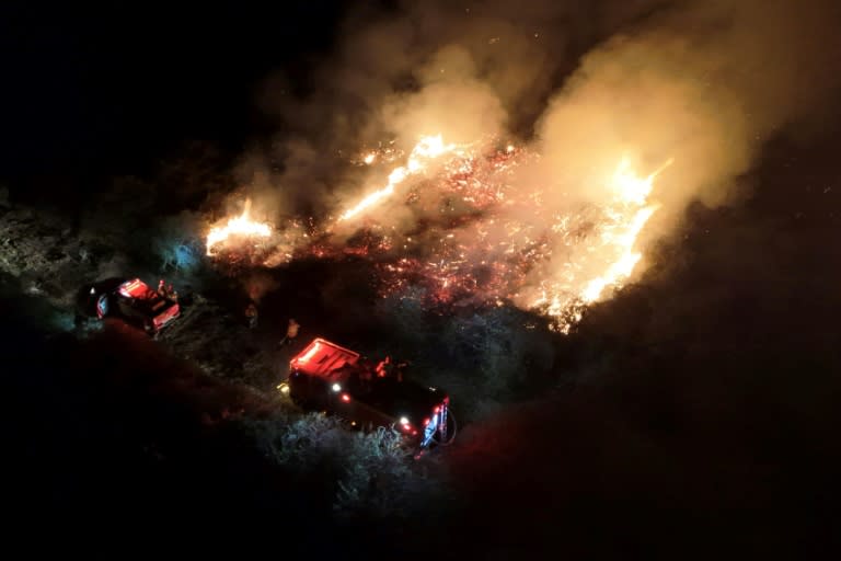 This handout photo released by the Mato Grosso do Sul Fire Department shows firefighters battling to control a wildfire in the Pantanal (Handout)