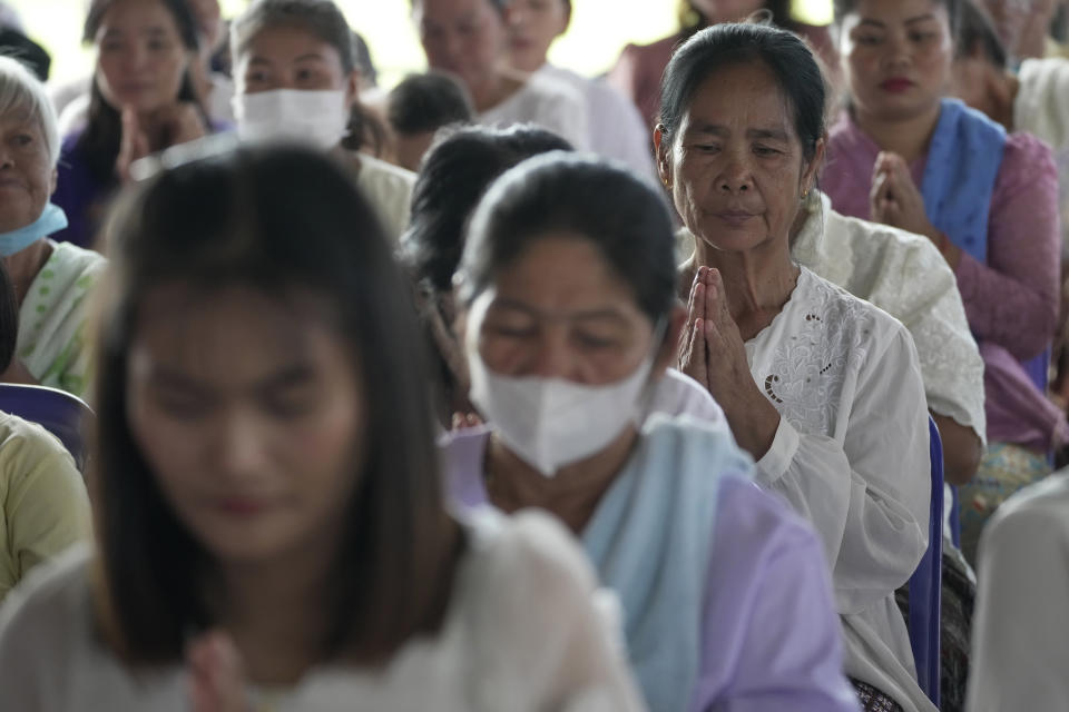 Relatives of the victims pray during the Buddhist ceremony in the rural town of Uthai Sawan, in Nong Bua Lamphu province, northeastern Thailand, Friday, Oct. 6, 2023. A memorial service takes place to remember those who were killed in a grisly gun and knife attack at a childcare center. A former police officer killed 36 children and teachers in the deadliest rampage in Thailand's history one year ago. (AP Photo/Sakchai Lalit)