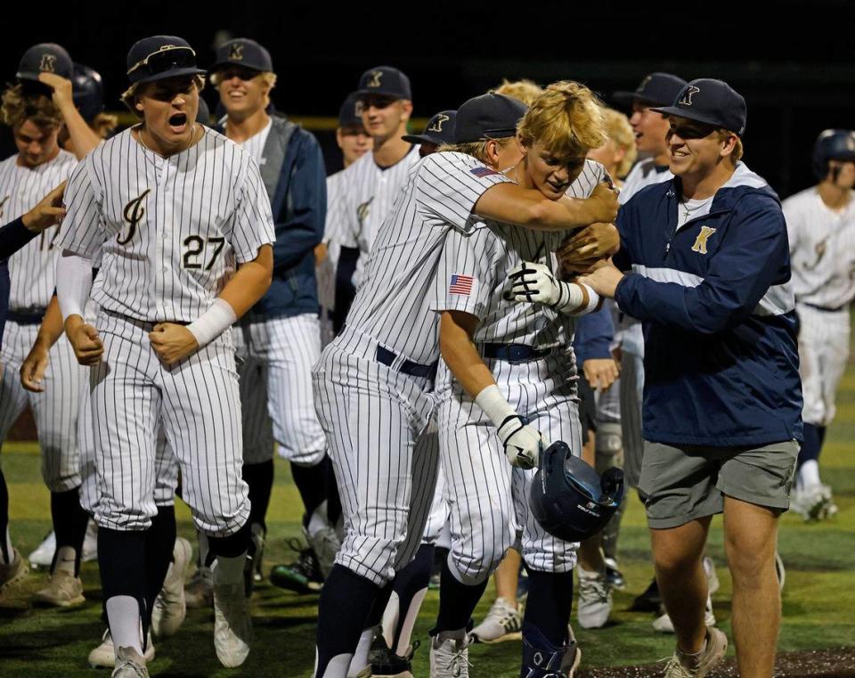 Team mates swarm Keller third baseman Cole Koeninger after his home run ended a UIL District 6A Region 1 Quarterfinals baseball game at L.D. Bell in Hurst, Texas, Thursday, May 16, 2024.