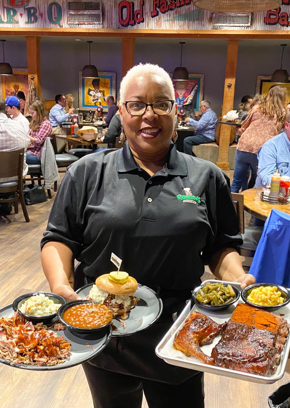 Anita McComb, a longtime server at Corky's, brings an order to a table at Corky's BBQ at 5259 Poplar Ave. in Memphis.