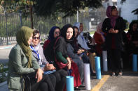 Delegates wait for transportation on the first day of the Afghan Loya Jirga meeting in Kabul, Afghanistan, Friday, Aug. 7, 2020. The traditional council opened Friday in the Afghan capital to decide the release of a final 400 Taliban - the final hurdle to the start of negotiations between Kabul’s leadership and the Taliban in keeping with a peace deal the United States signed with the insurgent movement in February. (AP Photo/Rahmat Gul)