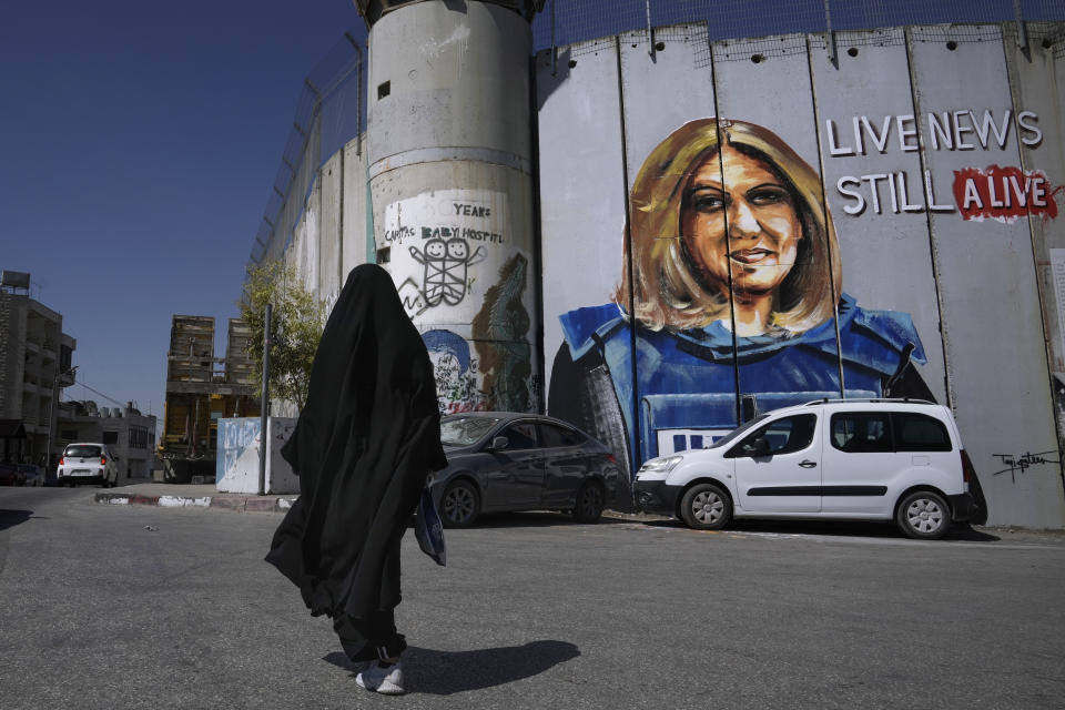 FILE - A mural by Palestinian artist Taqi Spateen depicts slain Palestinian-American journalist Shireen Abu Akleh on part of Israel's controversial separation barrier, in the West Bank city of Bethlehem, July 6, 2022. On Thursday, July 14, 2022, Lina Abu Akleh, the niece of the slain Al Jazeera journalist, is criticizing President Joe Biden for not meeting with her family as it presses the U.S. to hold Israel accountable for her death. (AP Photo/ Mahmoud Illean, File)
