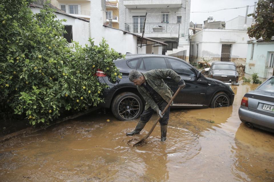 A man tries to remove floodwater from the area after torrential rains. (Photo: Ayhan Mehmet/Anadolu Agency via Getty Images)