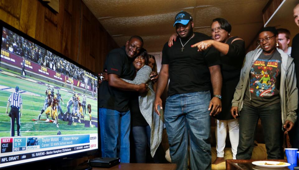 Back in 2017, friends and family of Taylor Moton, center, react upon viewing the official announcement that the Carolina Panthers had selected Moton in the second round of the NFL draft. Surrounding Moton as his parents' home in Okemos are (from left) Moton's dad Delbert Husband and aunt Gerry Stroman, mom Sonya Gunnings-Husband, and sister Shy Husband.