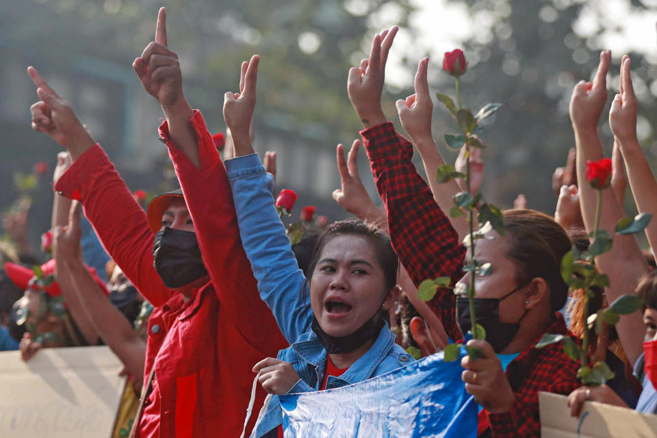 Protesters flash the three-fingered salute in Yangon, Myanmar on Sunday, Feb. 7, 2021. Thousands of people rallied against the military takeover in Myanmar's biggest city on Sunday and demanded the release of Aung San Suu Kyi, whose elected government was toppled by the army that also imposed an internet blackout. (AP Photo)