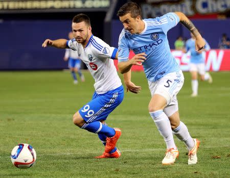 Jun 13, 2015; New York, NY, USA; Montreal Impact midfielder Eric Alexander (29) and New York City FC defender Jeb Brovsky (5) race for the ball during the second half at Yankee Stadium. New York City FC won 3-1. Mandatory Credit: Anthony Gruppuso-USA TODAY Sports