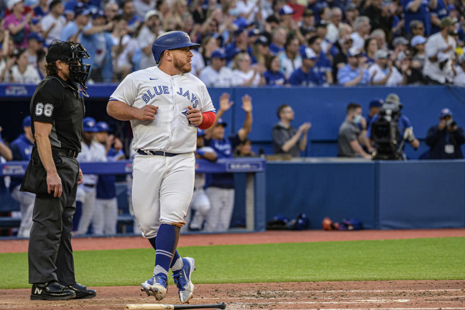 Toronto Blue Jays' Alejandro Kirk (30) scores on a single by Gabriel Moreno against the New York Yankees during the second inning of a baseball game Friday, June 17, 2022, in Toronto. (Christopher Katsarov/The Canadian Press via AP)