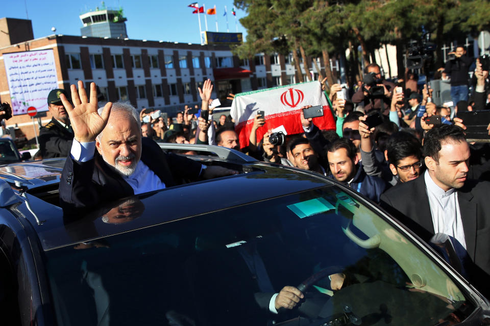 Iranian Foreign Minister Mohammad Javad Zarif, who is also Iran's top nuclear negotiator, waves to his well wishers upon arrival at the Mehrabad airport in Tehran, Iran, from Lausanne, Switzerland, Friday, April 3, 2015.  (AP Photo/Ebrahim Noroozi)