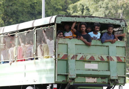 Rohinyga and Bangladeshi refugees are transported to a navy boat where they will be taken to mainland Malaysia, after they landed at Pantai Pasir Berdengung beach in Langkawi island, in the northern state of Kedah, Malaysia, May 14, 2015. REUTERS/Olivia Harris