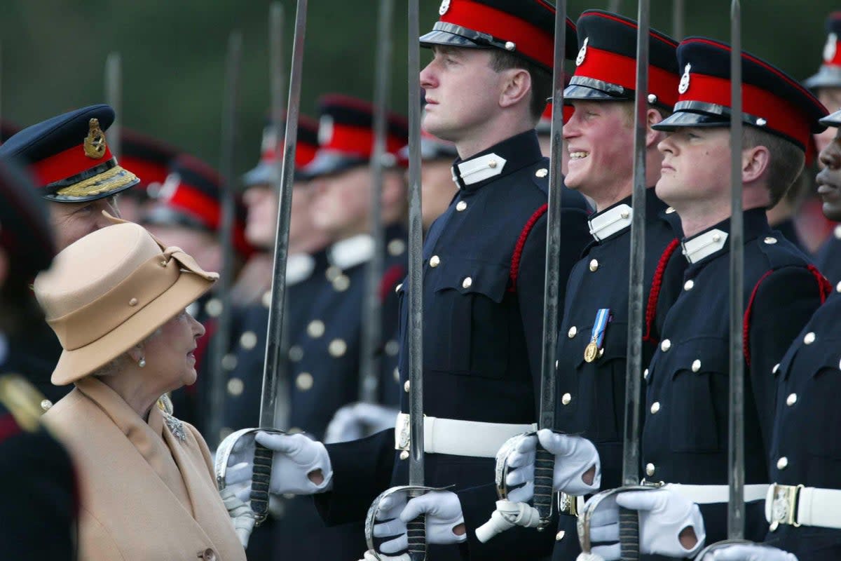 Harry smiling broadly as his grandmother the Queen reviewed him and other officers during the Sovereign’s Parade in 2006 (James Vellacott/PA) (PA Wire)