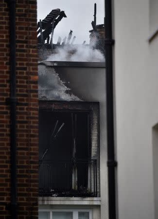 Damage can be seen to a low-rise block of buildings affected by a fire in Bethnal Green, northeast London, Britain, June 24, 2017. REUTERS/Hannah McKay