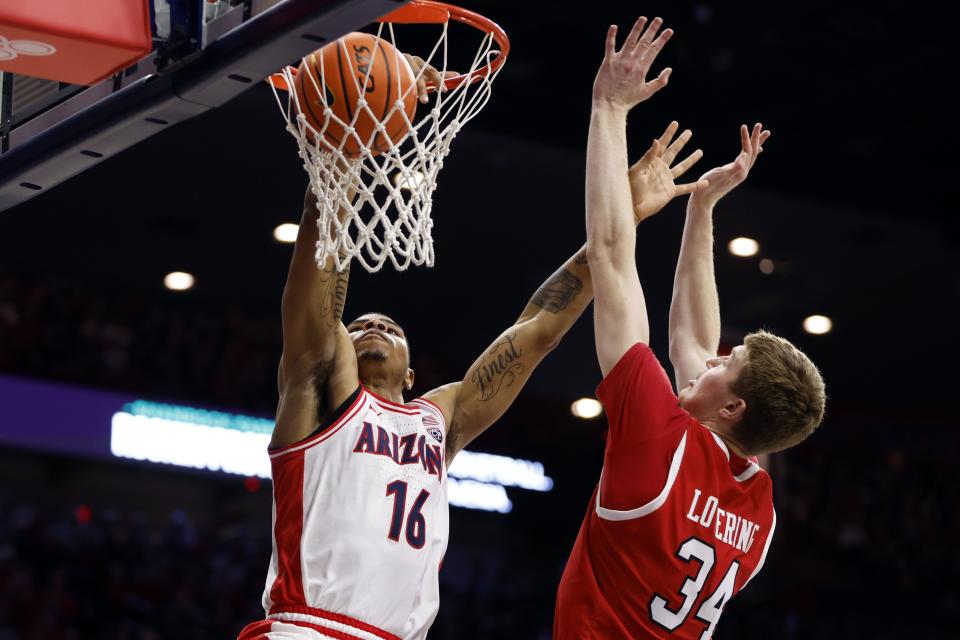 Arizona forward Keshad Johnson (16) dunks over Utah center Lawson Lovering during the second half of an NCAA college basketball game Saturday, Jan. 6, 2024, in Tucson, Ariz. | Chris Coduto, Associated Press