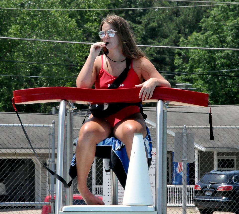 Orr Pool lifeguard Chloe Wolfe keeps an eye on hundreds of hot swimmers and has her safety equipment ready just in case.