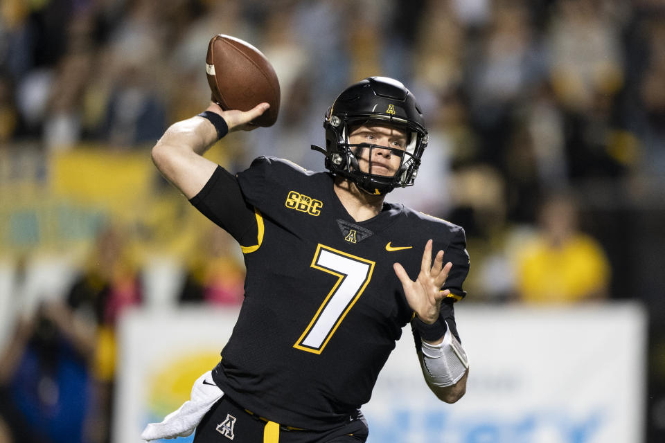 Appalachian State quarterback Chase Brice throws a pass during the first half of the team's NCAA college football game against Coastal Carolina on Wednesday, Oct. 20, 2021, in Boone, N.C. (AP Photo/Matt Kelley)