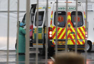 A health worker enters an ambulance outside the COVID-19 field hospital created in the International Convention Centre in Cape Town, South Africa, Monday, June 29, 2020. South Africa’s reported coronavirus are surging. Its hospitals are now bracing for an onslaught of patients, setting up temporary wards and hoping advances in treatment will help the country’s health facilities from becoming overwhelmed. (AP Photo/Nardus Engelbrecht)