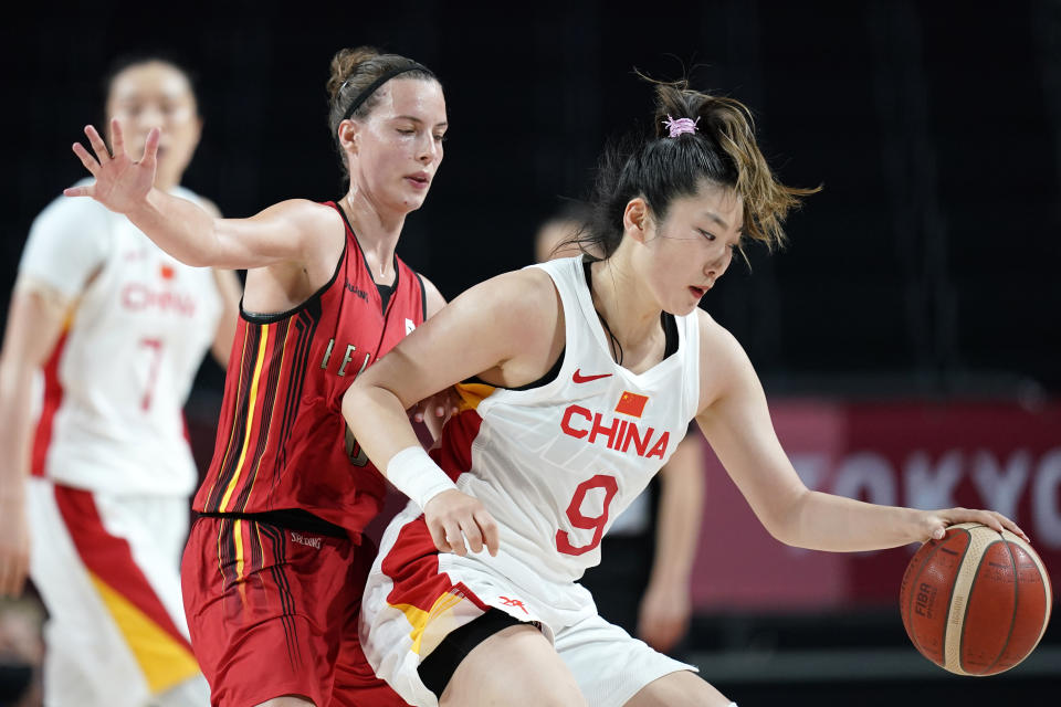 China's Meng Li (9) drives around Belgium's Antonia Delaere, left, during a women's basketball preliminary round game at the 2020 Summer Olympics, Monday, Aug. 2, 2021, in Saitama, Japan. (AP Photo/Charlie Neibergall)