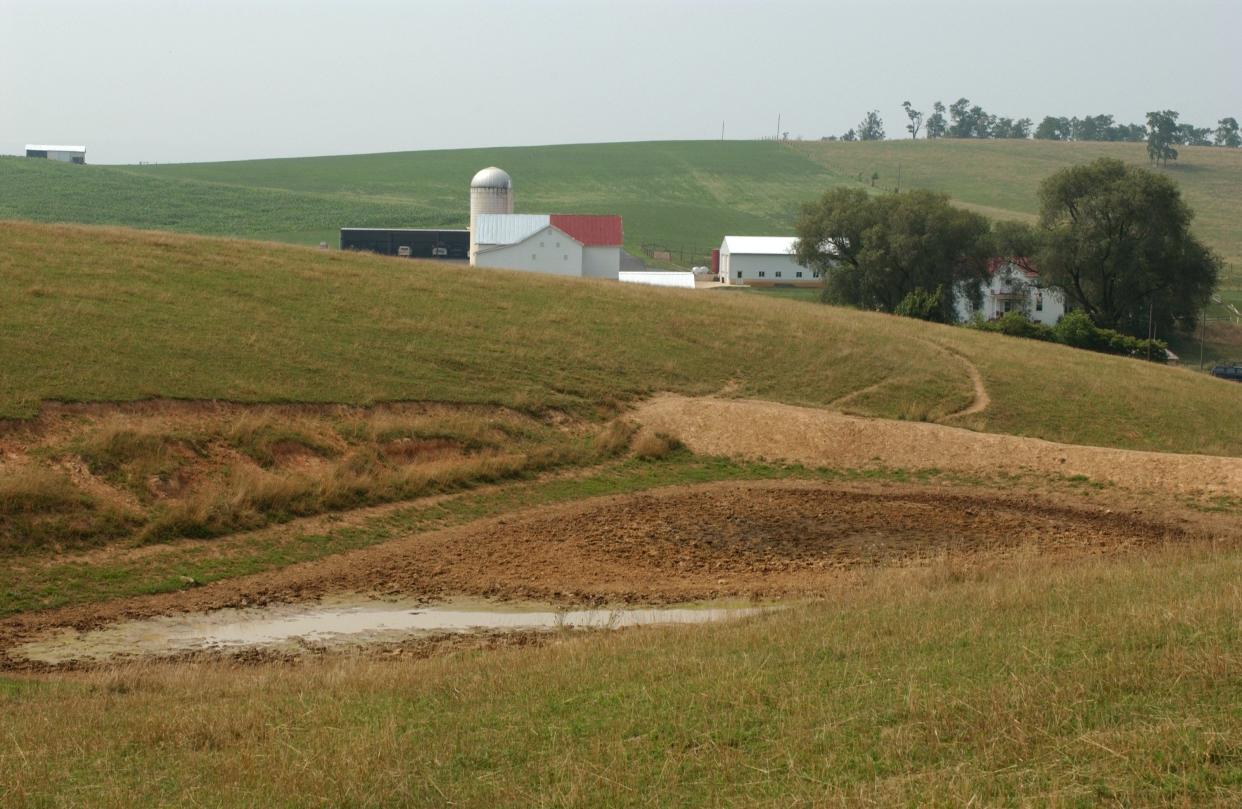 Photo taken in 2002 of a dry pond, one of 13 on the Glen Echo farm near Mount Solon run by the Mohler's. The family homeplace can be seen in the background.