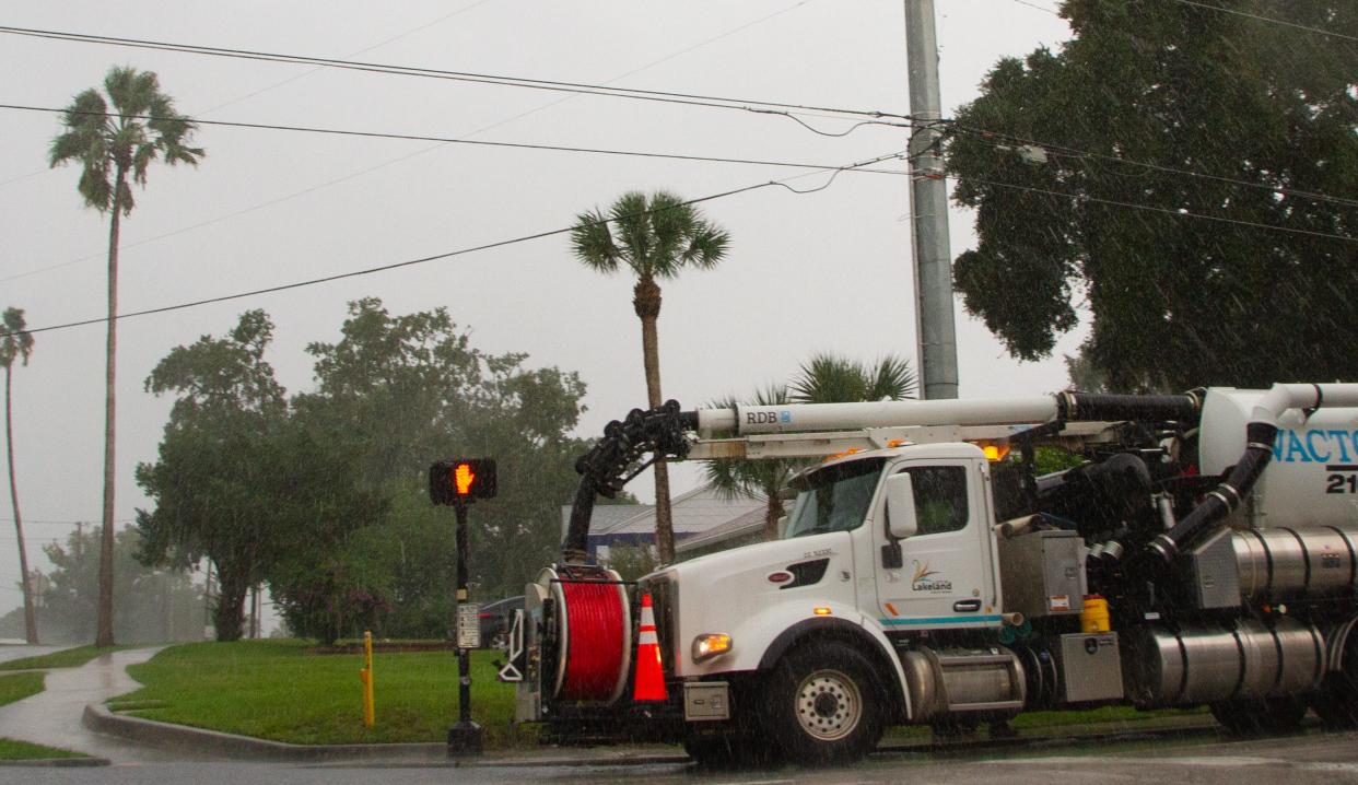 A truck from the City of Lakeland was stopped Wednesday morning at the corner of Beacon Road and Cleveland Heights Boulevard as workers checked on a storm drain amid rains from Hurricane Idalia.