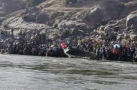 Ethiopians who fled the ongoing fighting in Tigray region prepare to cross the Setit River on the Sudan-Ethiopia border in Hamdait village in eastern Kassala state