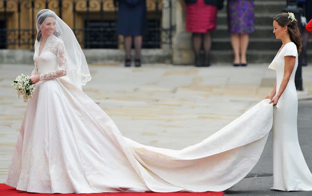 <p>Pascal Le Segretain/Getty</p> Catherine Middleton waves to the crowds as her sister and Maid of Honour Pippa Middleton holds her dress before walking in to the Abbey to attend the Royal Wedding of Prince William to Catherine Middleton at Westminster Abbey on April 29, 2011 in London, England.