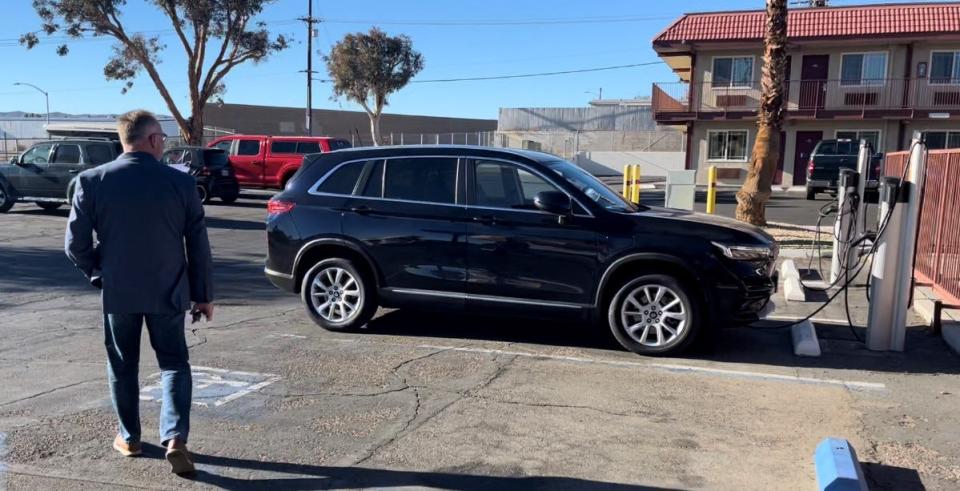 Alan Wagner, the recently appointed CEO of Liteborne Motor Corp., walks toward one of the electric SUVs made by China's Skywell Automotive Group that his company plans to sell in the United States as early as next year.