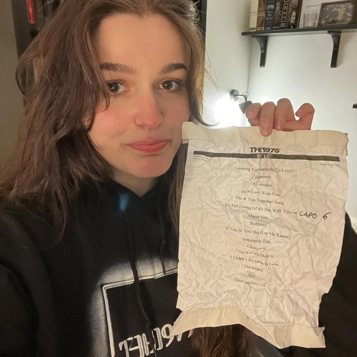 Emilie Christine, pictured with the set list from Friday’s show, filmed the moment Healy shared a kiss with a festival worker (Emilie Christine/PA)