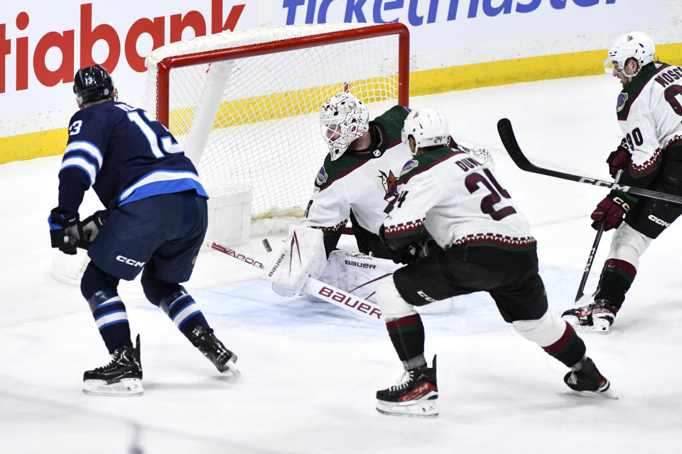 Winnipeg Jets center Gabriel Vilardi (13) scores on Arizona Coyotes goaltender Connor Ingram (39) during the first period of an NHL hockey game in Winnipeg, Manitoba on Sunday, Feb. 25, 2024. (Fred Greenslade/The Canadian Press via AP)