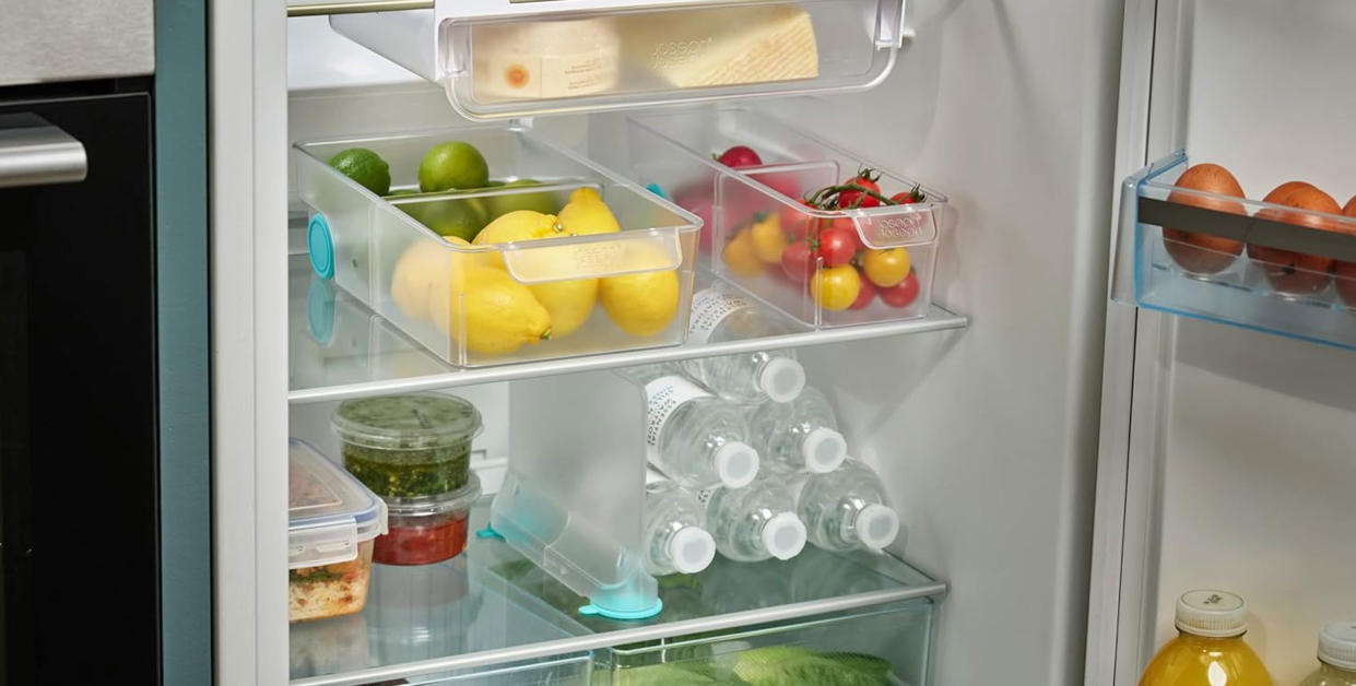  An organized fridge with storage drawers and dividers. 