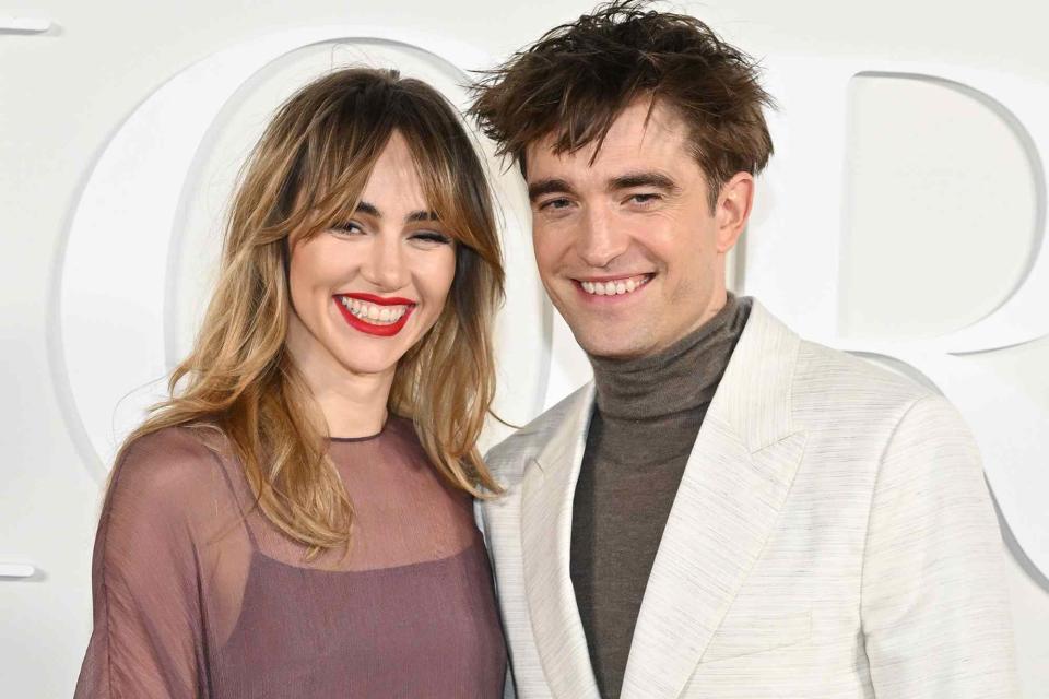 <p>Stephane Cardinale - Corbis/Corbis/Getty</p> Suki Waterhouse and Robert Pattinson attend the Dior Fall 2023 Menswear Show on December 03, 2022 in Giza, Egypt.