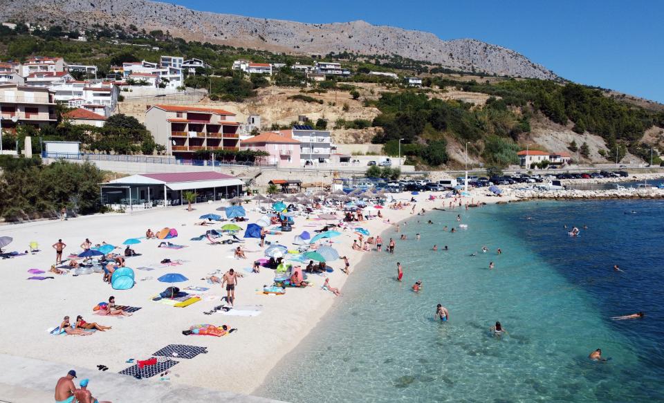 Crowds of people, including foreign tourists, enjoy the sun and the sea on August 21, 2020, in Split on the central Adriatic coast. - As United Kingdom removed Croatia from the list of "safe countries" to travel due to rising number of cases of COVID-19 throughout the country, many British tourists arrived at airport to return back to their country because of stricter measures when returning from Croatia. (Photo by Damir SENCAR / AFP) (Photo by DAMIR SENCAR/AFP via Getty Images)