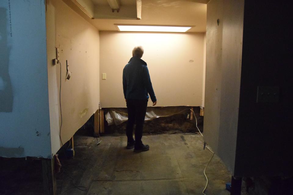 Julienne Tomatoes owner Julie Adams stands in the restaurant's basement on Wednesday, May 18, after a sewer backup caused flooding damage.