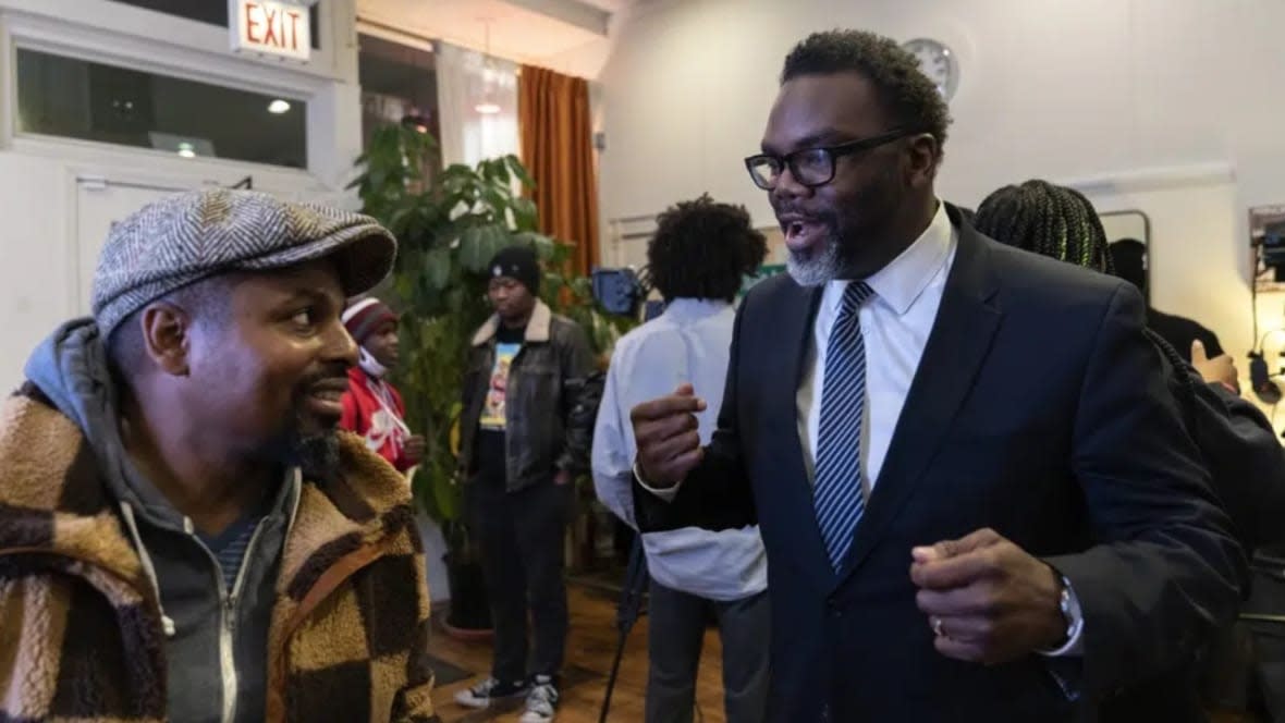 Chicago mayoral candidate Brandon Johnson (right) speaks with Bobby Price during a public listening session at Principle Barbers in December in the North Lawndale neighborhood of Chicago. Johnson is endorsed by the Chicago Teachers Union, a group that has tangled with Chicago Mayor Lori Lightfoot, including during an 11-day teachers strike during her first year in office. (Photo: Erin Hooley/AP, File)