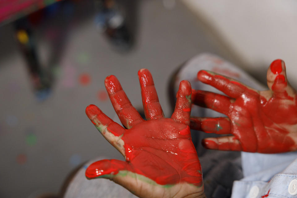 Ace-Liam Nana Sam Ankrah, who will turn two in July, shows his hands gull of paint at his mother's art gallery in Accra, Ghana, Monday, May 27, 2024. Ankrah has set the record as the world's youngest male artist. His mother, Chantelle Kukua Eghan, says it all started by accident when her son, who at the time was 6 months old, discovered her paints. (AP Photo/Misper Apawu)