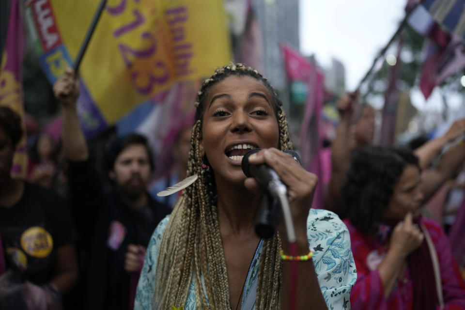 FILE - Danieli Balbi, who is running for office as a Communist Party of Brazil candidate for a seat as a state representative, speaks to supporters during the "March of Flowers" against machismo, violence against women, homophobia and against President Jair Bolsonaro's government, in Rio de Janeiro, Brazil, Wednesday, Sept. 21, 2022. Balbi has a doctorate in Literature Science, is also a screenwriter and was the first transsexual teacher at the Federal University of Rio de Janeiro. (AP Photo/Silvia Izquierdo)