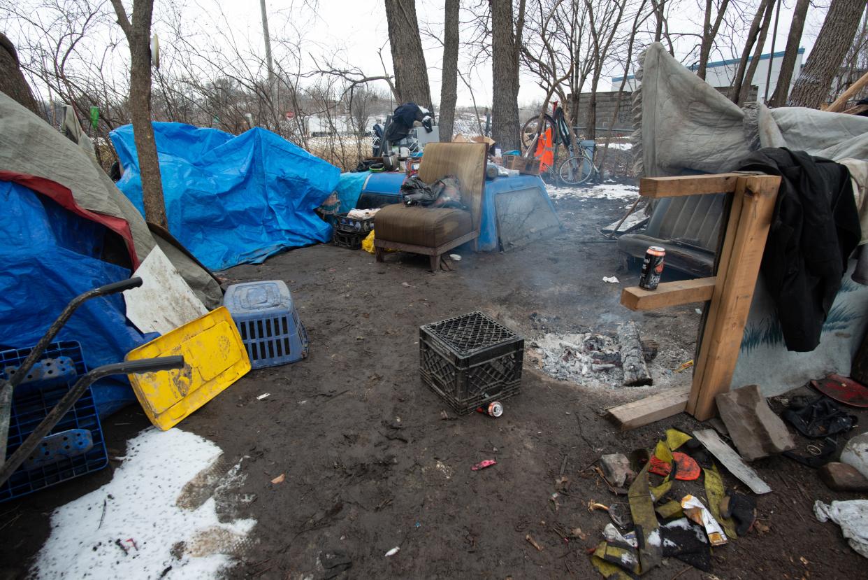 A small fire burns last week in the middle of an area where unsheltered people have been living in makeshift tents near S.E. 15th and Adams. Topeka elected officials plan Feb. 7 to consider paying a consultant $76,080 to help the city aid unsheltered residents more humanely and proactively.