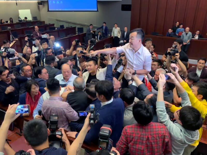 FILE PHOTO: Pro-democracy lawmakers clash with pro-Beijing lawmakers during a meeting for control of a meeting room to consider the controversial extradition bill in Hong Kong