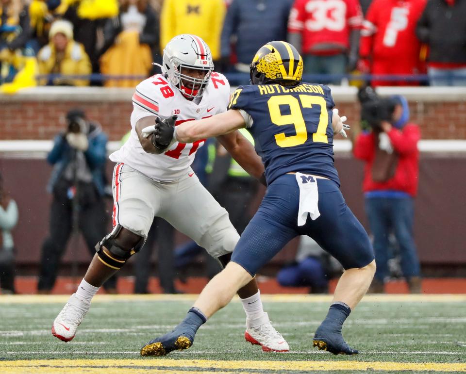 Ohio State Buckeyes offensive tackle Nicholas Petit-Frere (78) tries to block Michigan Wolverines defensive end Aidan Hutchinson (97) during the third quarter in a NCAA College football game at Michigan Stadium at Ann Arbor, Mi on November  27, 2021. 