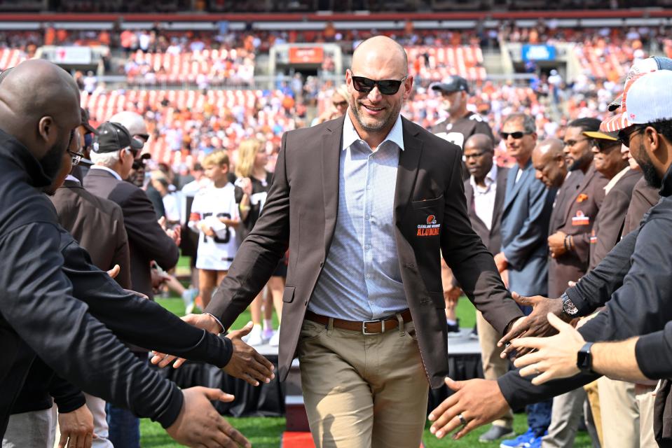 Former Browns left tackle Joe Thomas is greeted by former teammates as he is honored in a ceremony at halftime of a game against the New York Jets , Sunday, Sept. 18, 2022, in Cleveland.