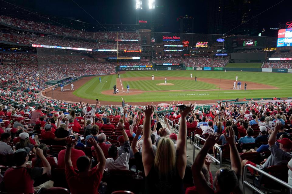 Fans do The Wave as the St. Louis Cardinals play the Chicago Cubs during the sixth inning of a baseball game Friday, May 21, 2021, in St. Louis. (AP Photo/Jeff Roberson)