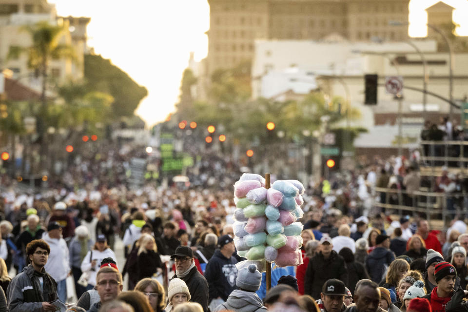 A vendor sells cotton candy along the 134th Rose Parade route in Pasadena, Calif., Monday, Jan. 2, 2023. (Sarah Reingewirtz/The Orange County Register via AP)