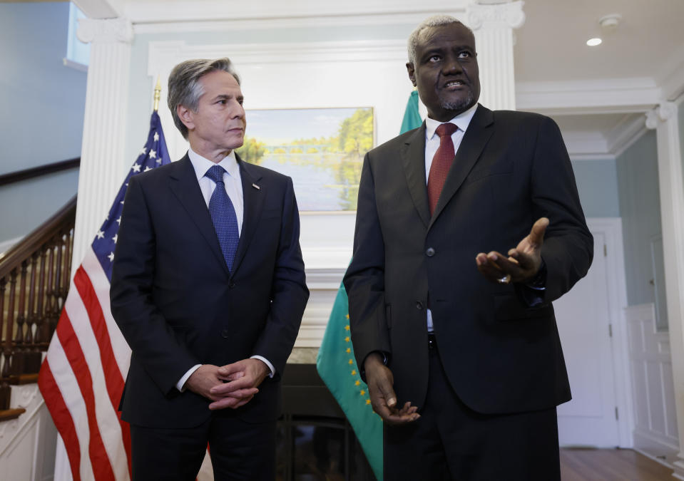 FILE - Secretary of State Antony Blinken listens as African Union Commission Chairperson Moussa Faki Mahamat speaks on Oct. 27, 2022, in Ottawa, Ontario, Canada. The White House previewed one major summit announcement on Friday, Dec. 9, saying that President Joe Biden would use the U.S-Africa Leaders Summit to declare his support for adding the African Union as a permanent member of the Group of 20 nations. (Blair Gable/Pool Photo via AP, File)