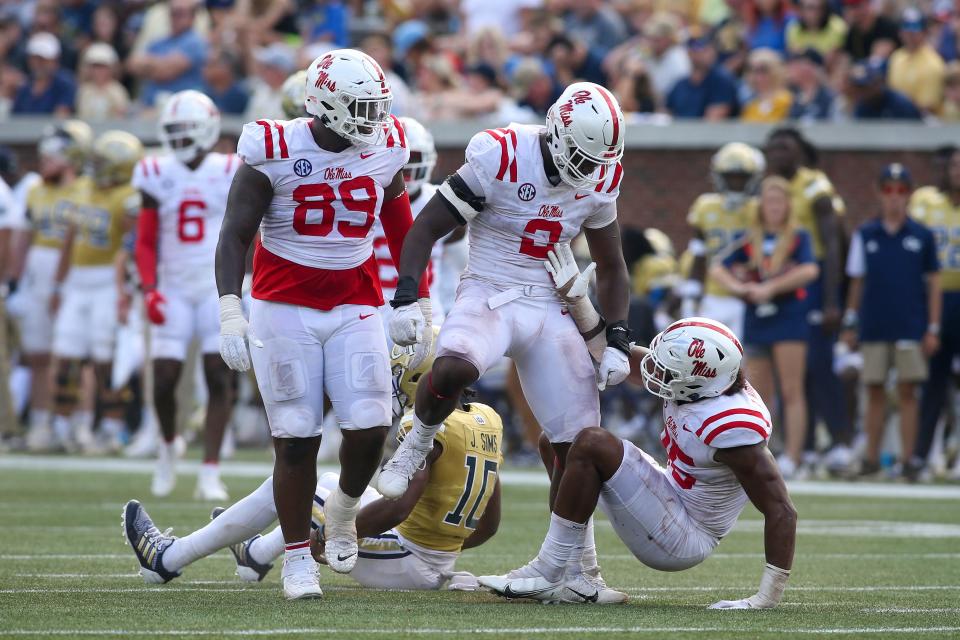 Mississippi defensive end Cedric Johnson (2) celebrates after a tackle with defensive tackle JJ Pegues (89) and defensive end Tavius Robinson (95) against Georgia Tech.