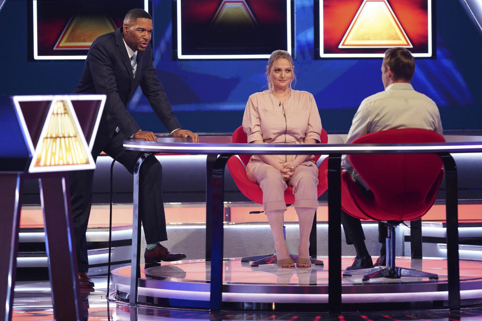 This image released by ABC shows host Michael Strahan, left, with contestants on "The $100,000 Pyramid." (Christopher Willard/ABC via AP)